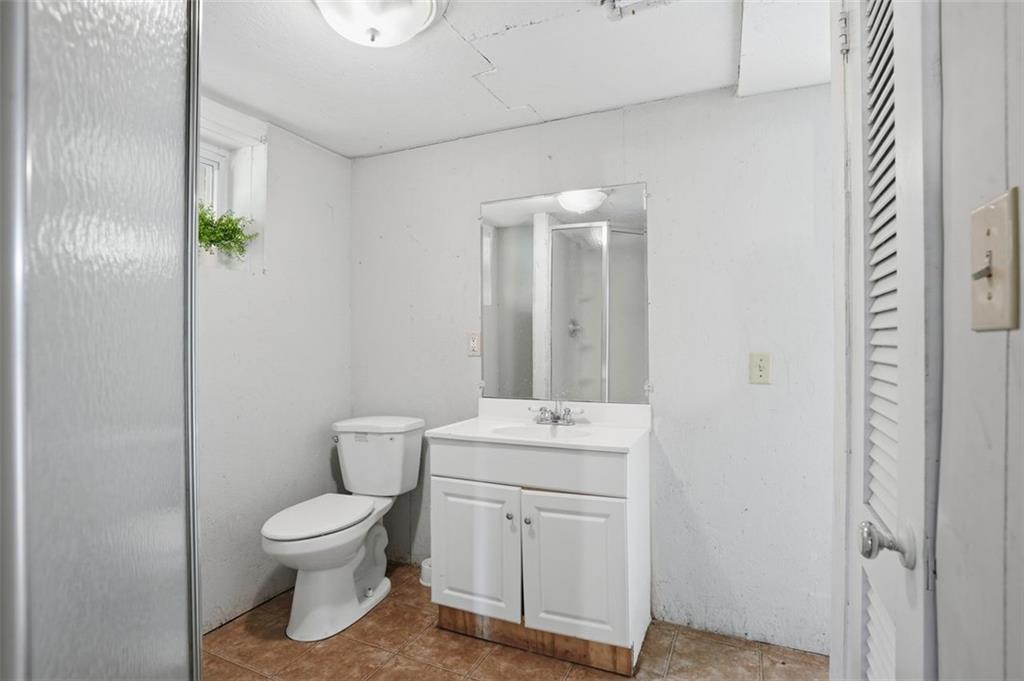 345 Brannan Road McDonough, GA 30253 - Photo 23 of 34 a bathroom with a toilet sink and mirror