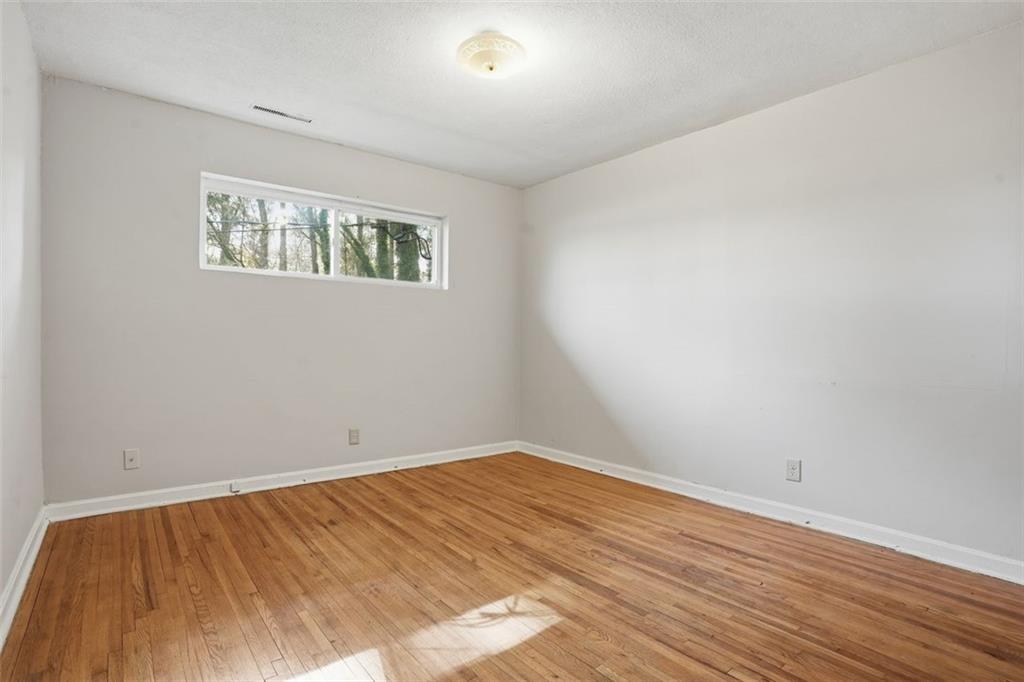 345 Brannan Road McDonough, GA 30253 - Photo 8 of 34 an empty room with wooden floor