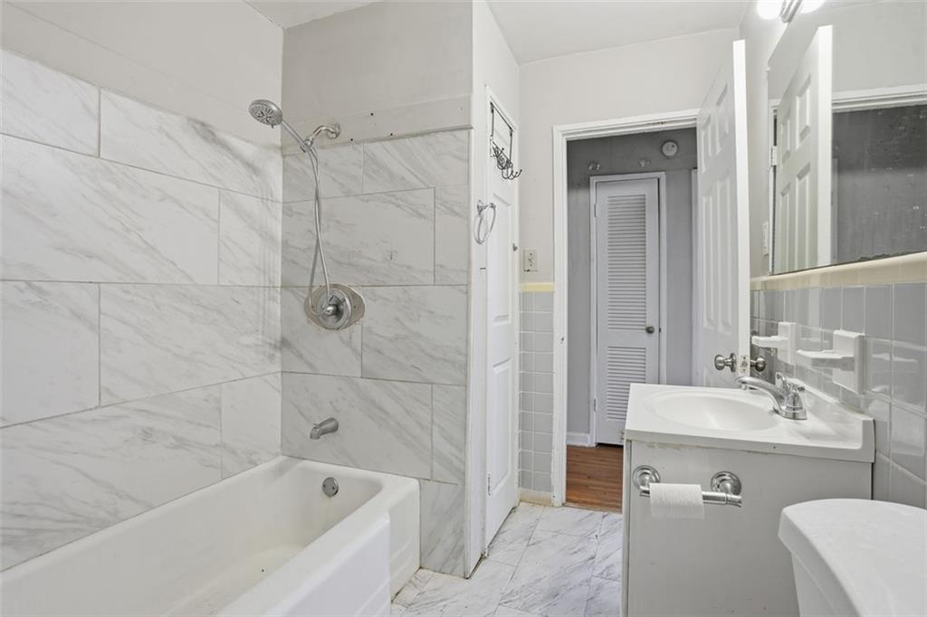 345 Brannan Road McDonough, GA 30253 - Photo 9 of 34 a bathroom with a bathtub shower sink vanity and toilet