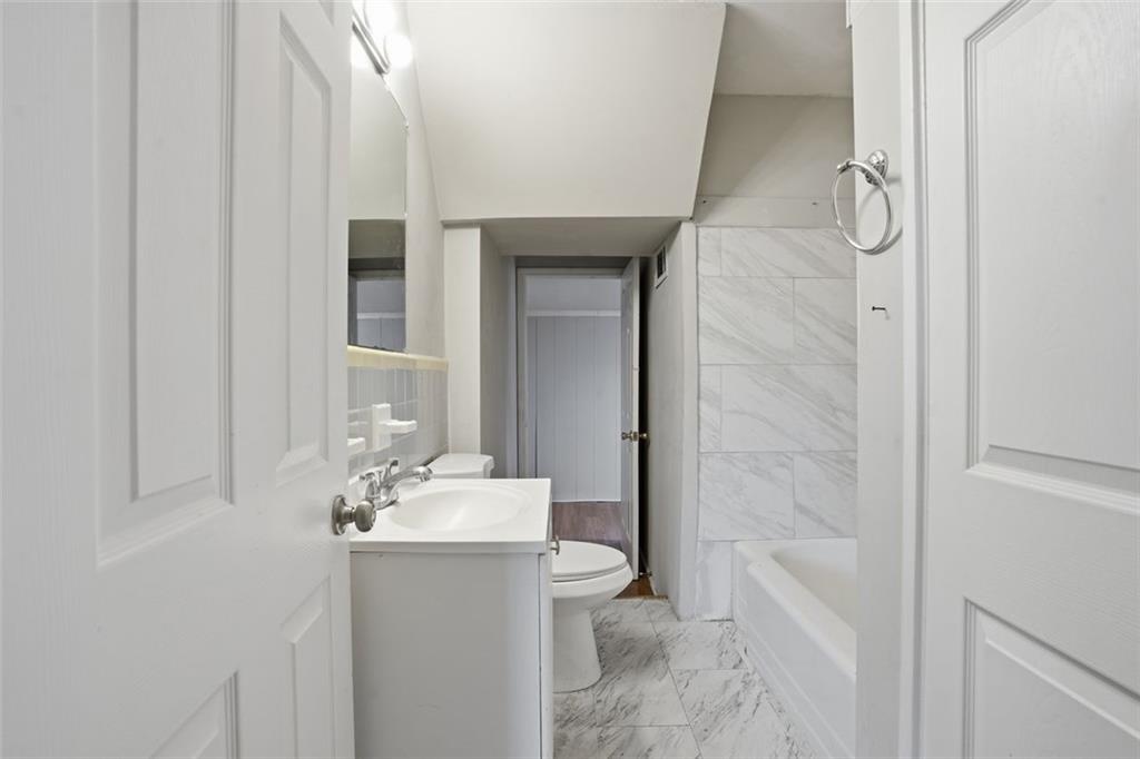 345 Brannan Road McDonough, GA 30253 - Photo 10 of 34 a bathroom with a sink a toilet and shower