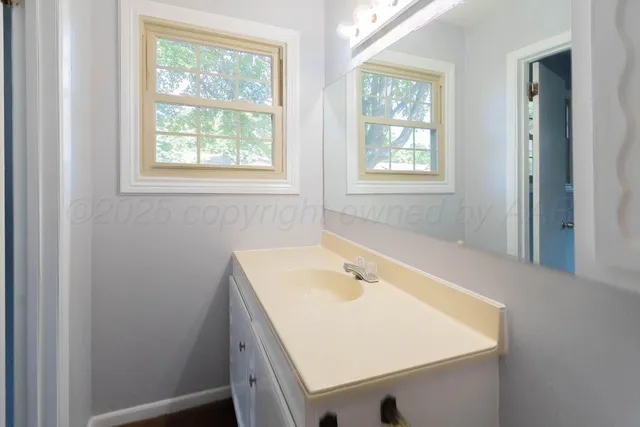 a bathroom with a glass shower door