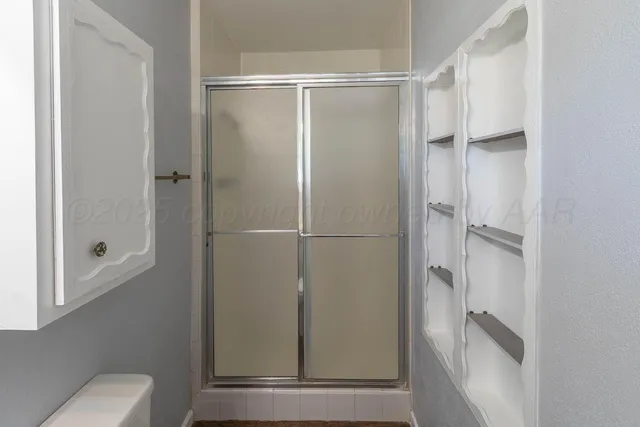 a front view of a house with a yard and potted plants