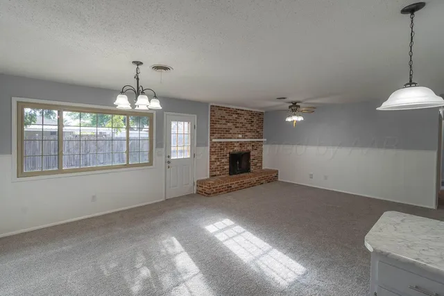 a view of empty room with a fireplace