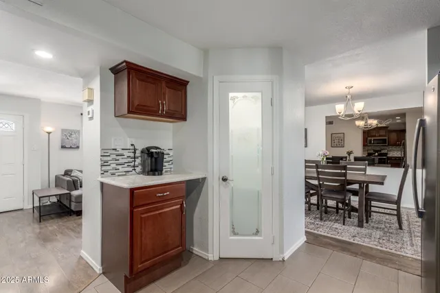 a kitchen with cabinets and chairs