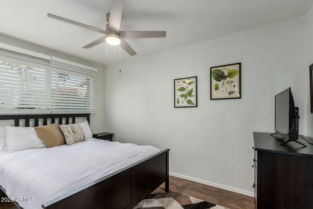 a bedroom with a bed and a flat tv screen