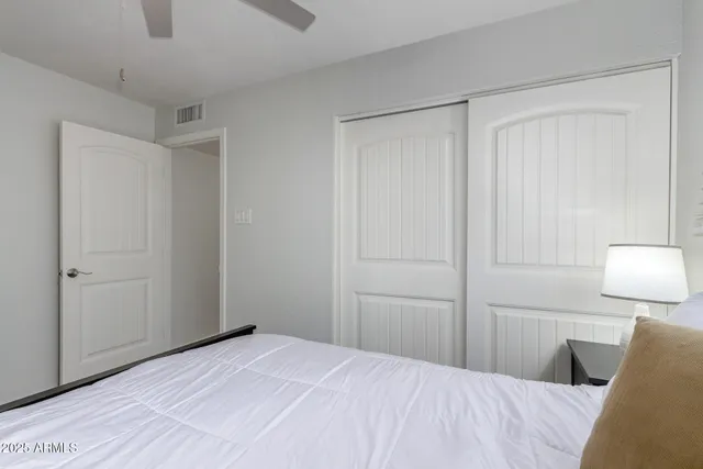 a bedroom with a bed and a lamp