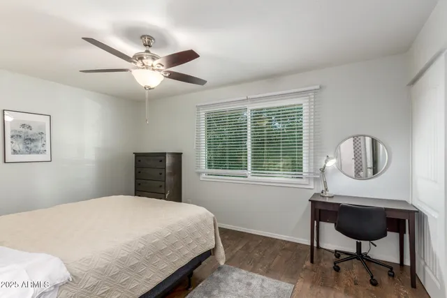 a bedroom with a bed a chair and a window