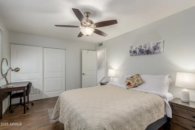 a bedroom with a bed and a chandelier