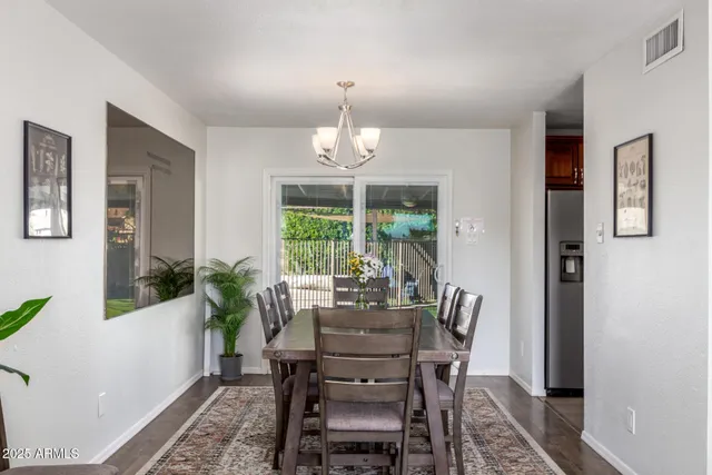 a dining room with furniture window and wooden floor