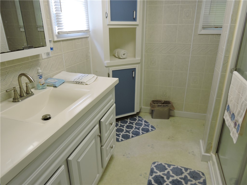 1901 Hattons Ford Road Townville, SC 29689 - Photo 18 of 33 A well-maintained bathroom offers practical storage solutions with built-in cabinetry and a bright window.