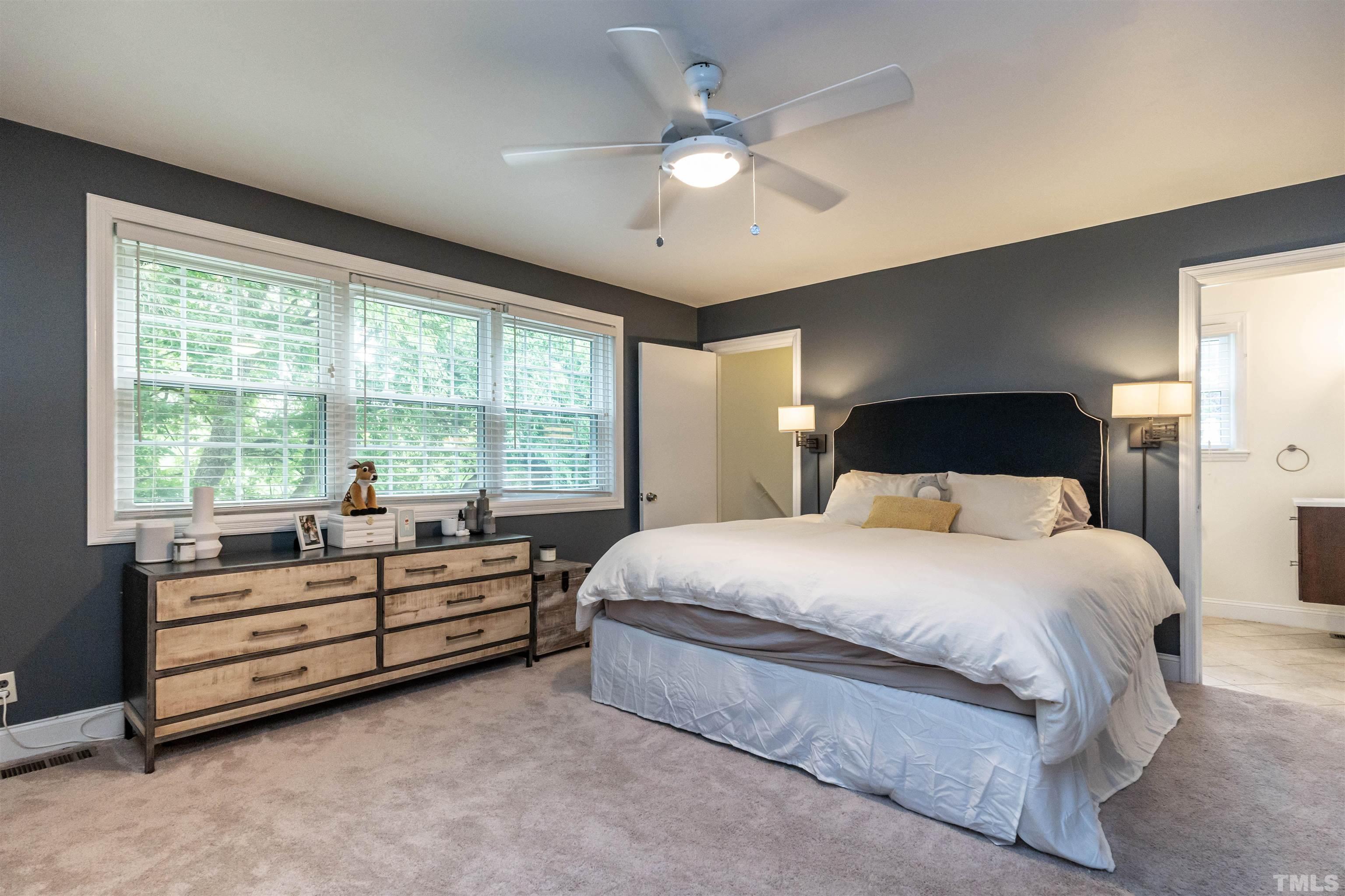 1204 Clifton Street Raleigh, NC 27604 - Photo 13 of 26 a bedroom with a large bed and a large window