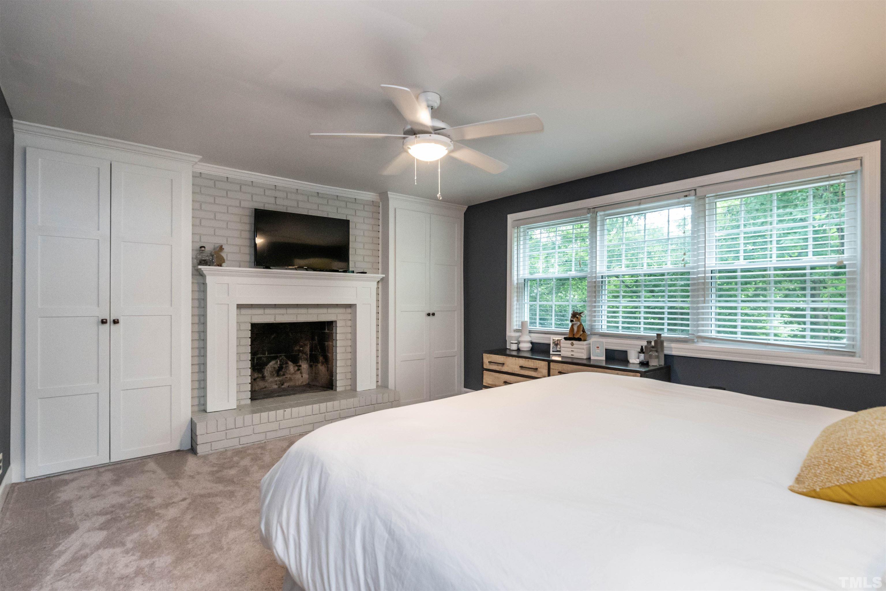 1204 Clifton Street Raleigh, NC 27604 - Photo 14 of 26 a spacious bedroom with a large bed and a flat screen tv