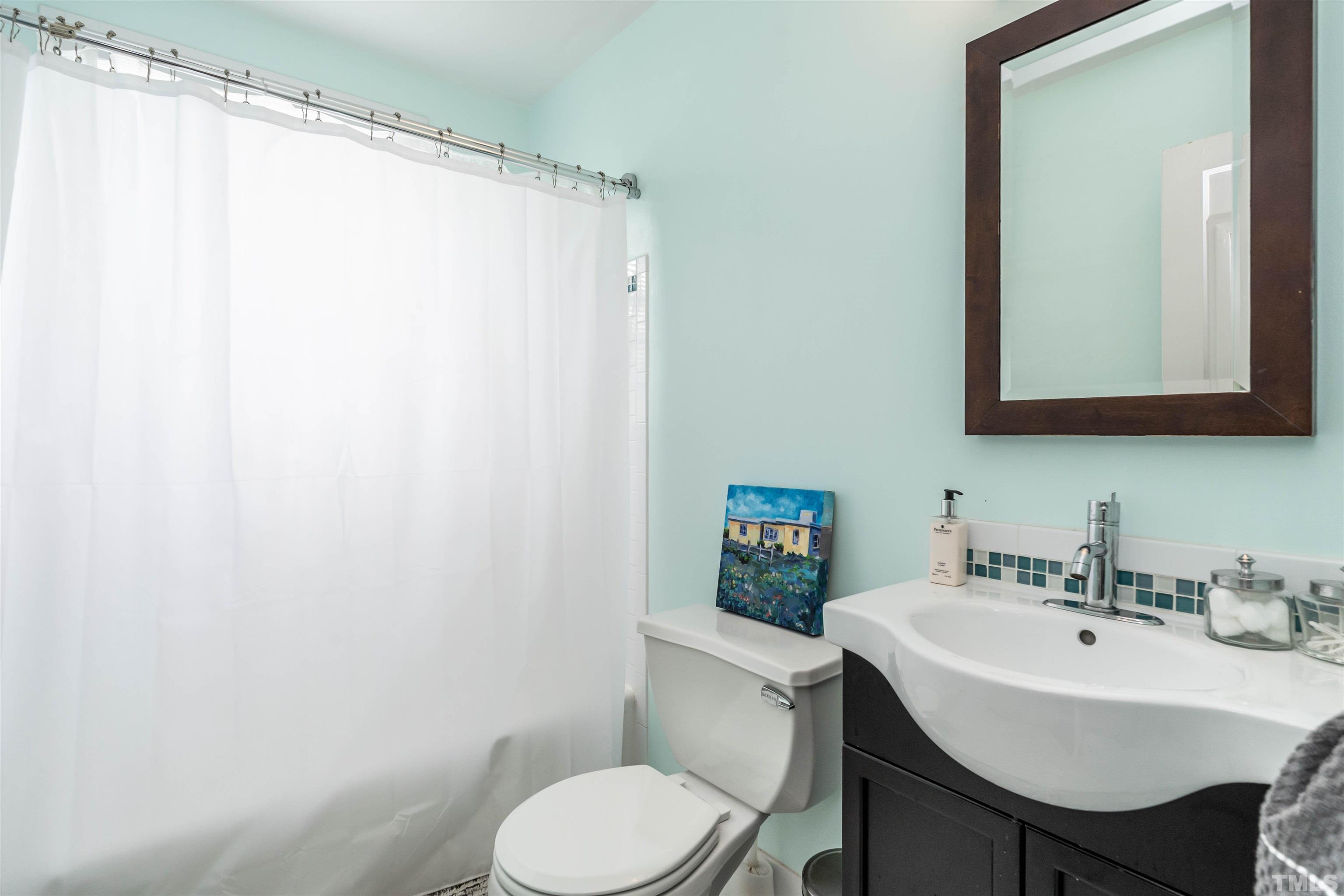 1204 Clifton Street Raleigh, NC 27604 - Photo 17 of 26 a white toilet sitting next to a bathroom sink