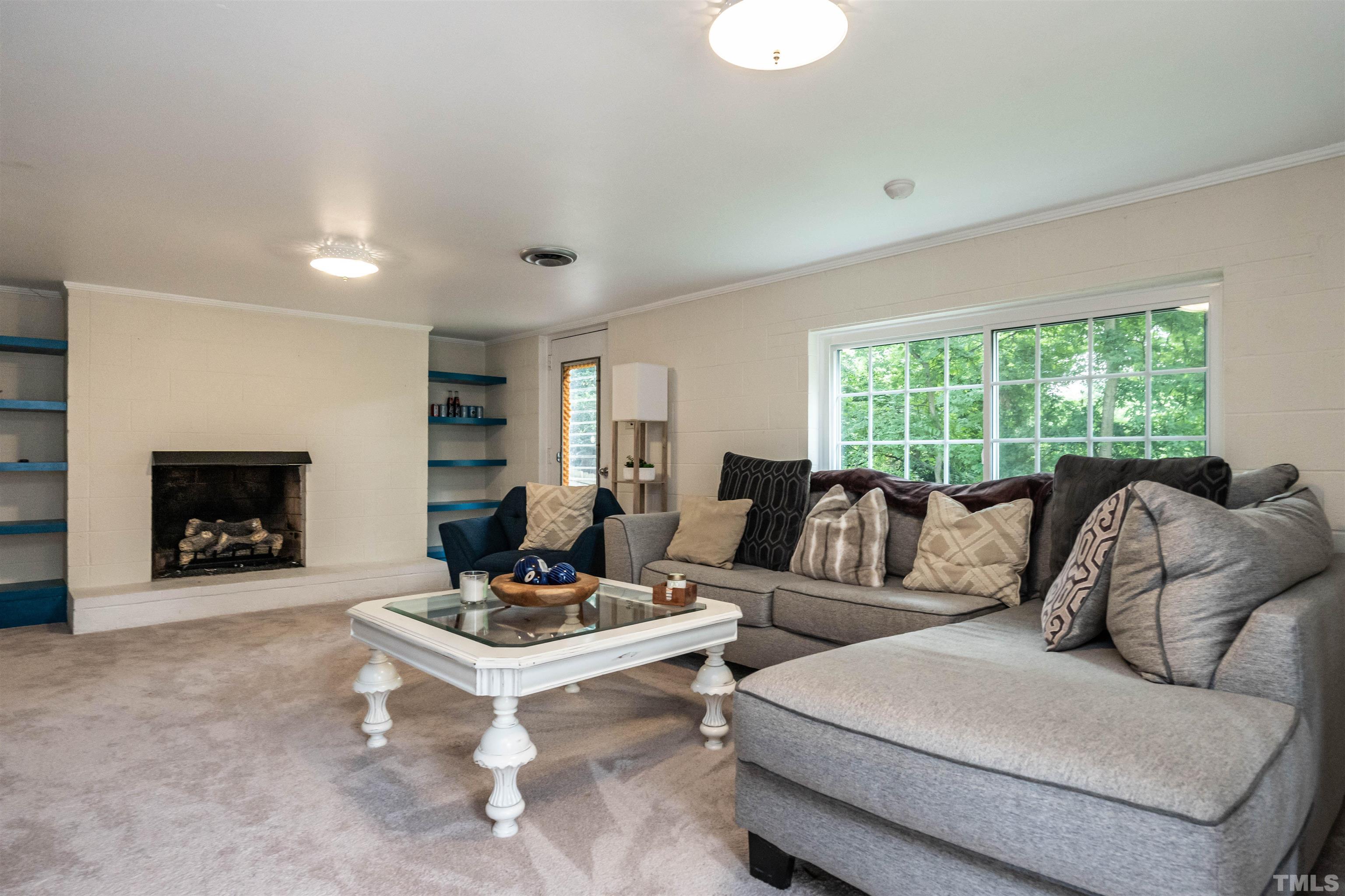 1204 Clifton Street Raleigh, NC 27604 - Photo 19 of 26 a living room with furniture and a fireplace