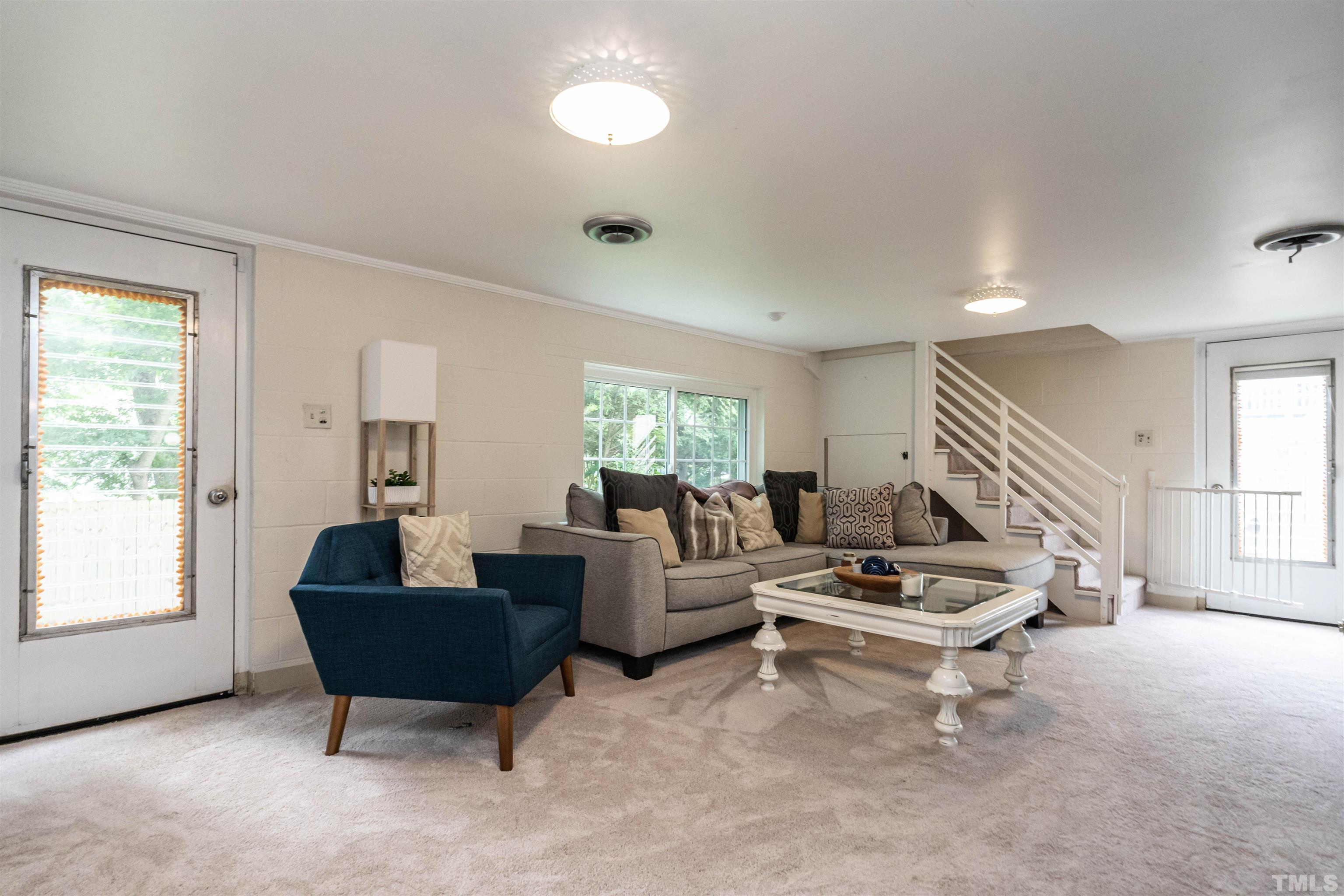 1204 Clifton Street Raleigh, NC 27604 - Photo 20 of 26 a living room with furniture and a potted plant