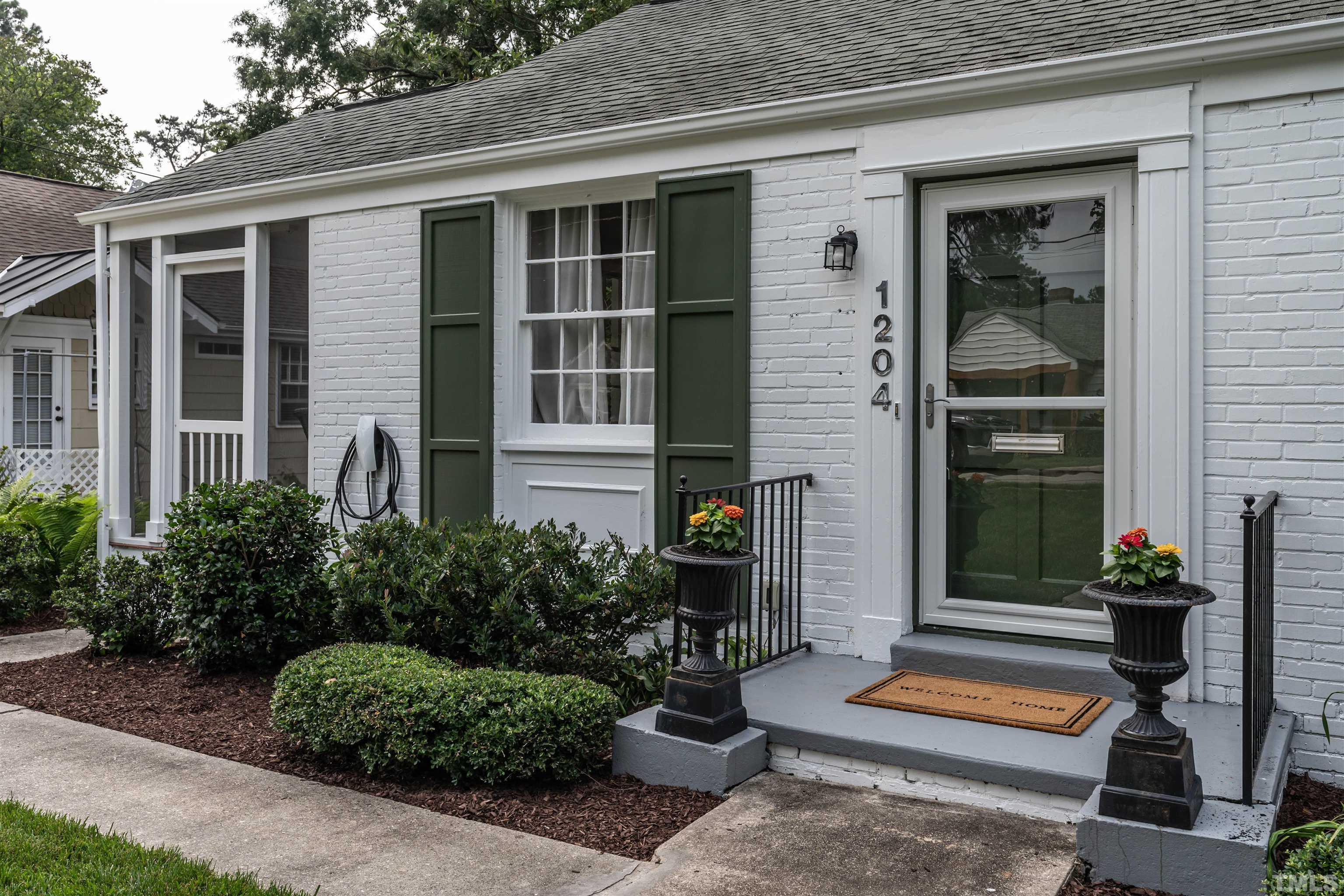 1204 Clifton Street Raleigh, NC 27604 - Photo 2 of 26 a front view of a house with a yard