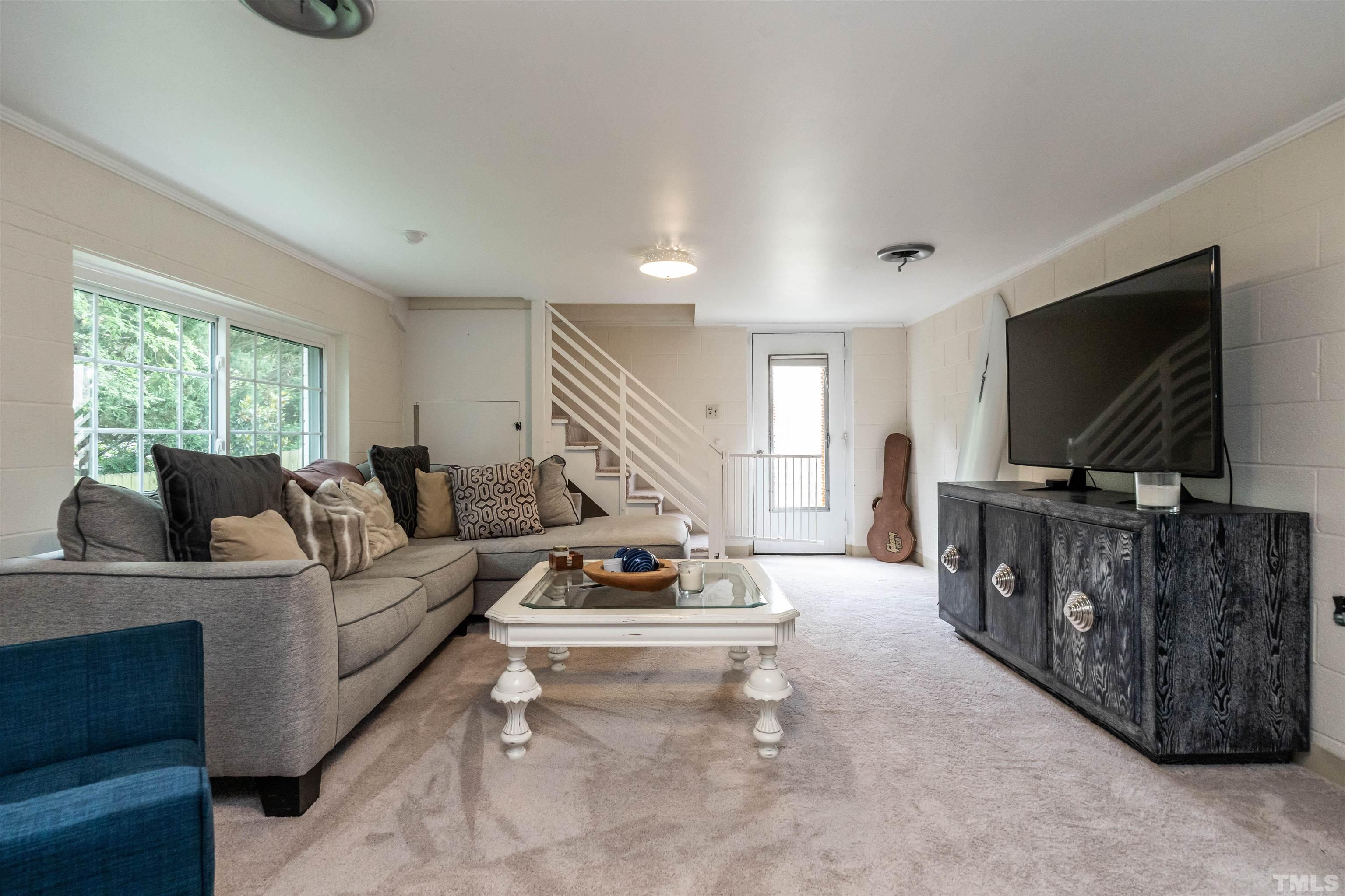 1204 Clifton Street Raleigh, NC 27604 - Photo 21 of 26 a living room with furniture and a flat screen tv