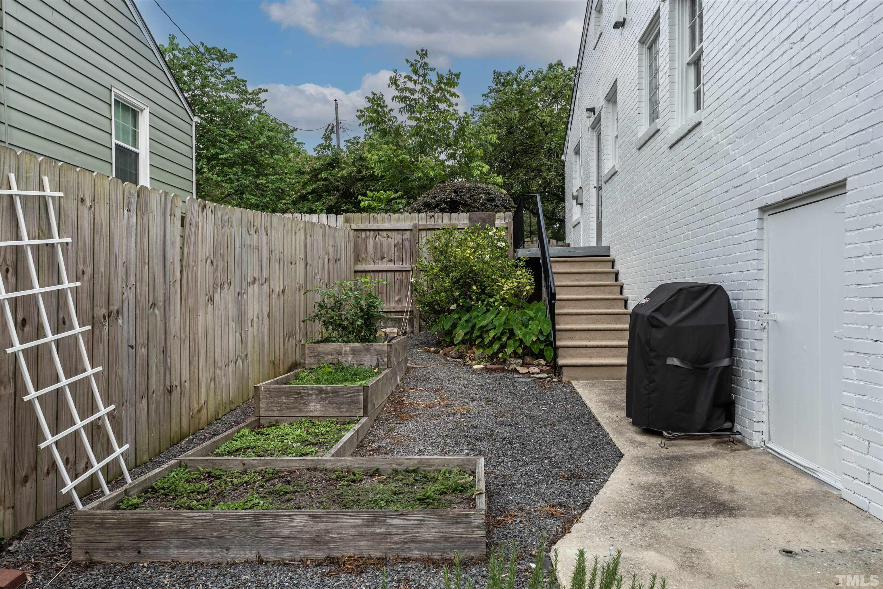 1204 Clifton Street Raleigh, NC 27604 - Photo 26 of 26 a view of a chair with potted plants in front of door