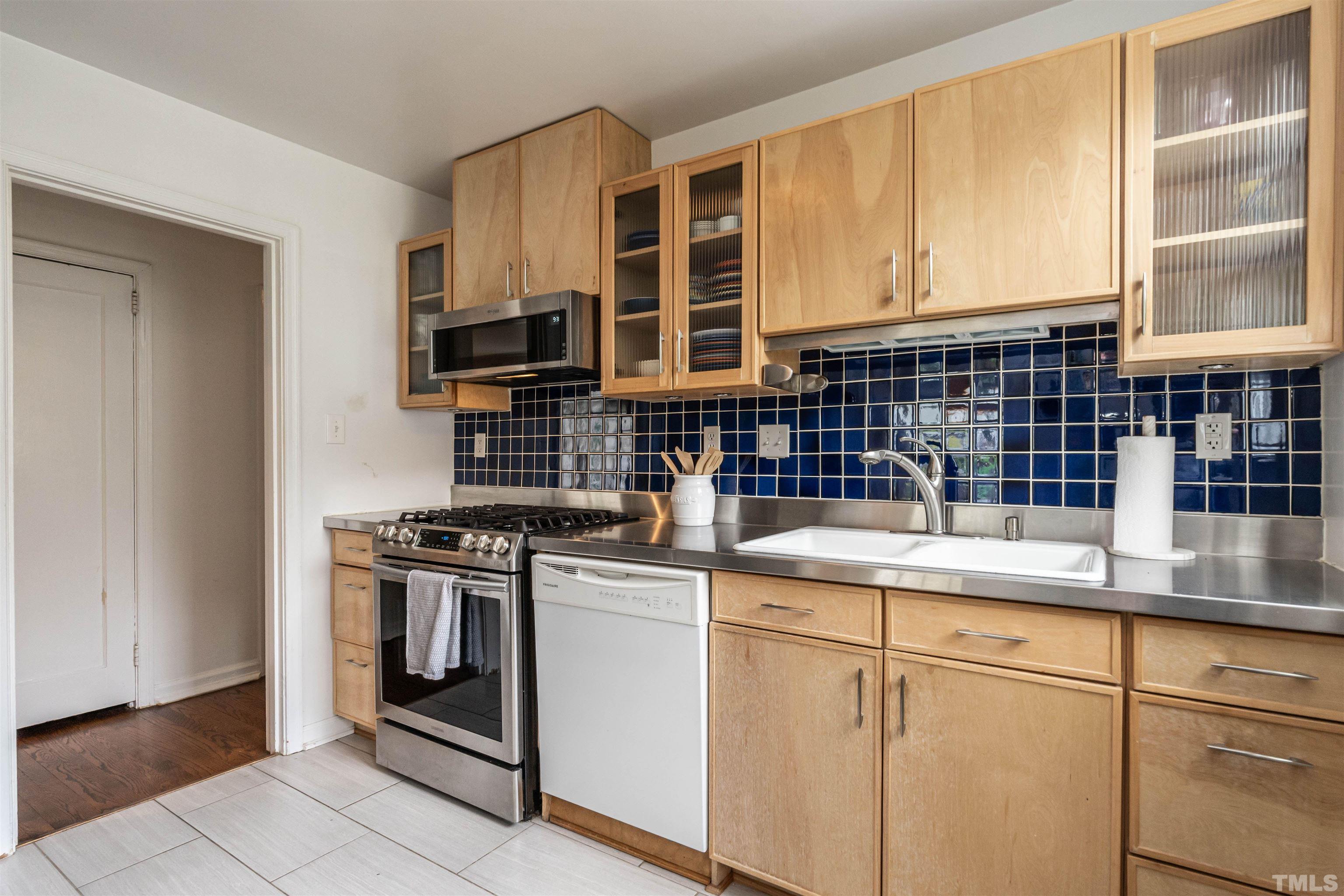1204 Clifton Street Raleigh, NC 27604 - Photo 8 of 26 a kitchen with stainless steel appliances granite countertop a stove and a sink