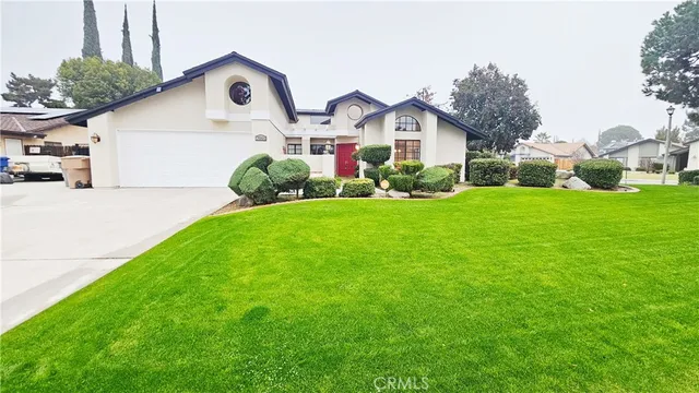 a front view of house with yard and green space