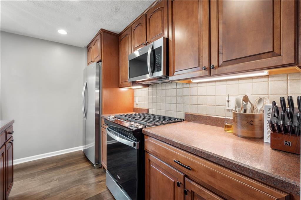 137 Walnut Strand Imperial, PA 15126 - Photo 12 of 37 a kitchen with granite countertop a stove and a wooden floor