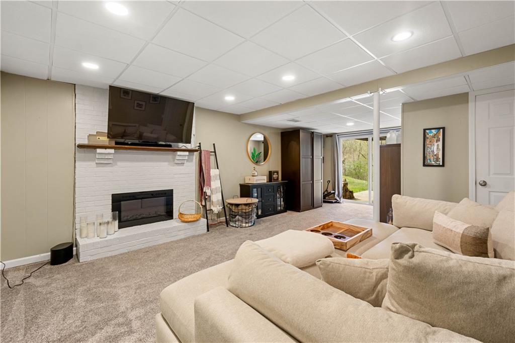 137 Walnut Strand Imperial, PA 15126 - Photo 21 of 37 a living room with furniture a fireplace and a flat screen tv