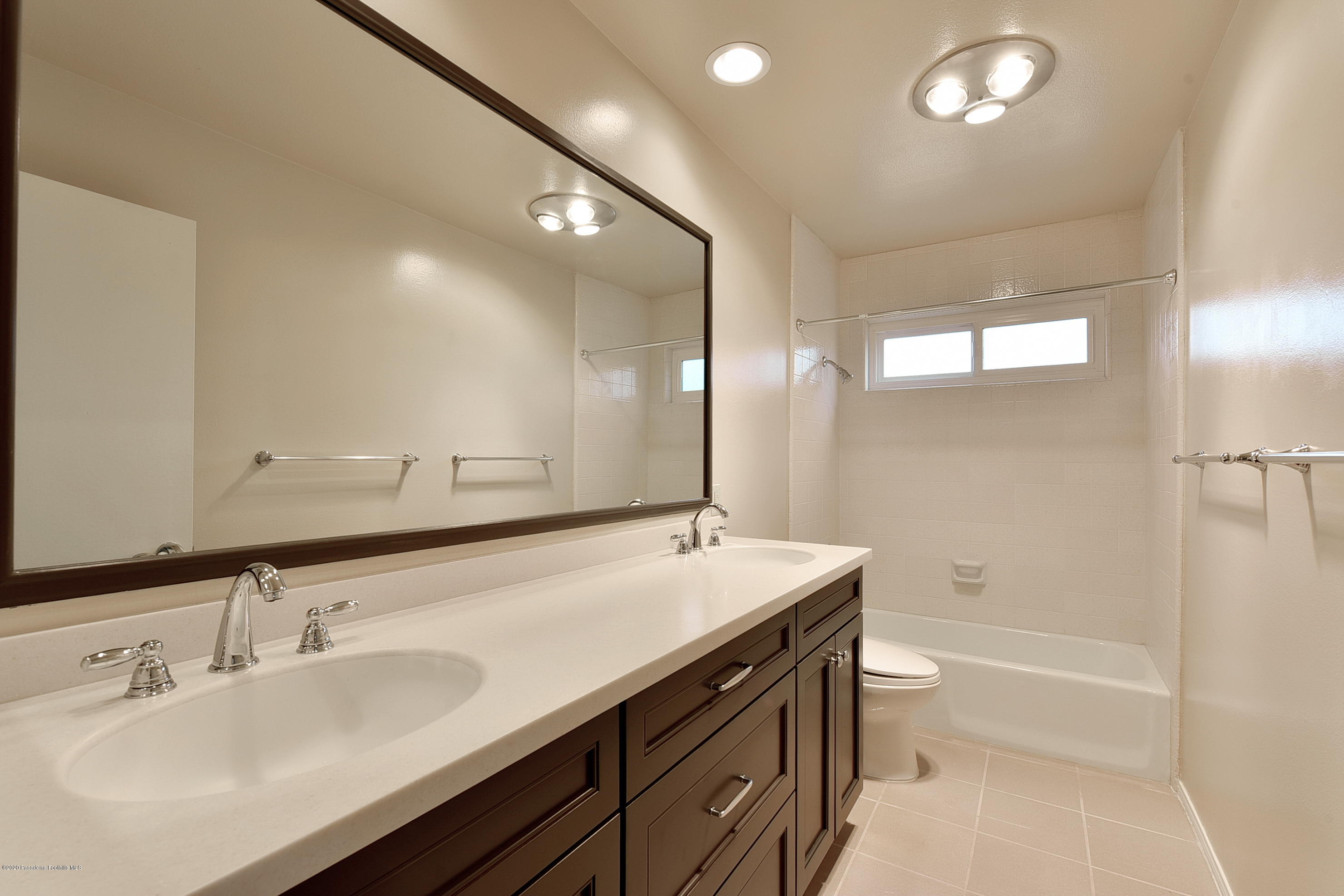 3107 Chadney Drive Glendale, CA 91206 - Photo 15 of 26 a bathroom with a double vanity sink toilet mirror and bathtub