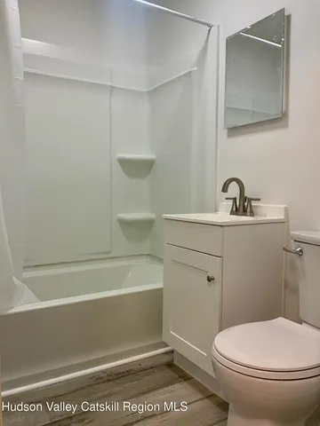 a bathroom with a toilet a sink and bathtub