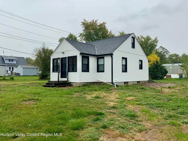 a view of a house with a backyard