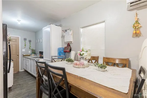 a dining room with furniture and wooden floor