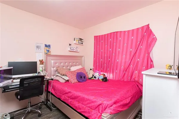 a bedroom with a bed and a chair