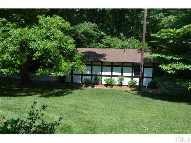 1701 Baker Road Raleigh, NC 27607 - Photo 20 of 25 a view of house with backyard and outdoor seating