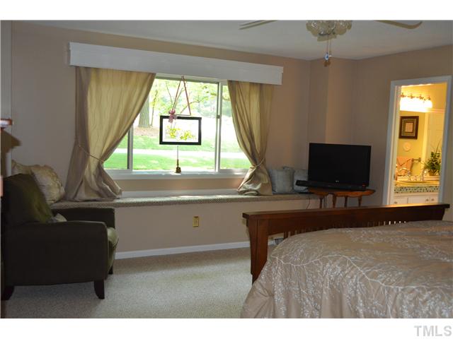 1701 Baker Road Raleigh, NC 27607 - Photo 8 of 25 a bedroom with a bed and a flat screen tv
