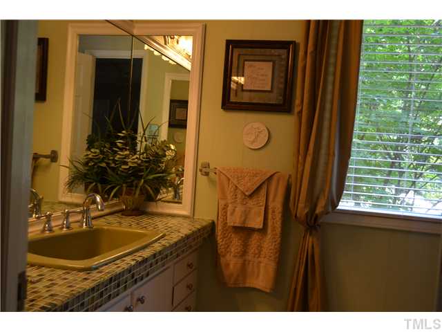 1701 Baker Road Raleigh, NC 27607 - Photo 9 of 25 a bathroom with a sink and a mirror