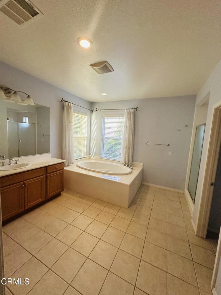 13687 Blue Ridge Way Moorpark, CA 93021 - Photo 12 of 46 a bathroom with a sink a mirror and a bathtub