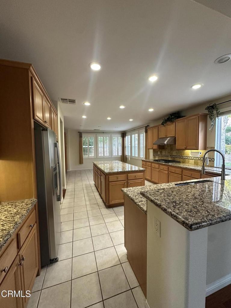 13687 Blue Ridge Way Moorpark, CA 93021 - Photo 8 of 46 a kitchen with stainless steel appliances granite countertop a sink and a refrigerator