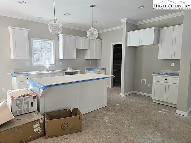 a kitchen with a sink appliances and cabinets