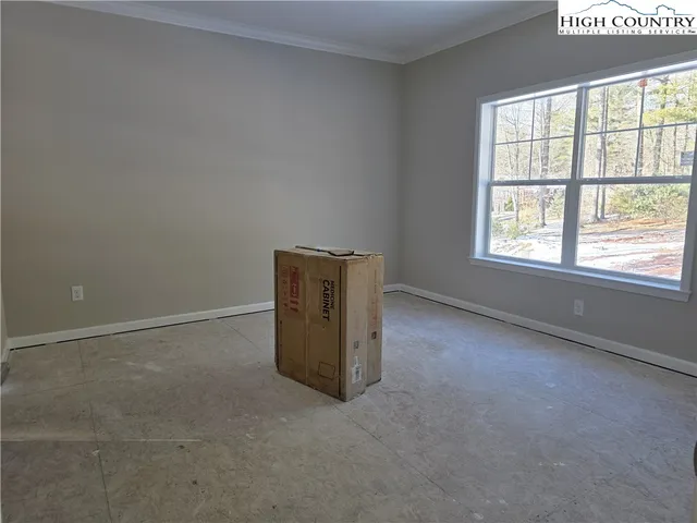 an empty room with a empty space and windows
