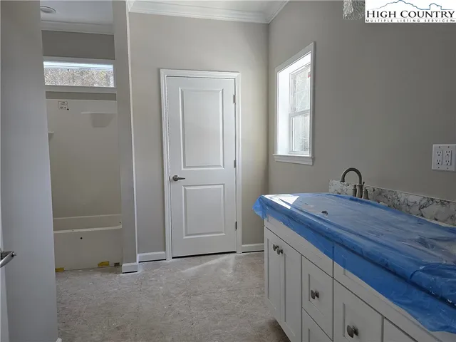 a room with a sink and a mirror