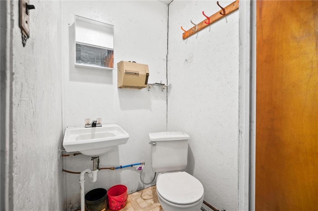 1677 Shady Plain Road Apollo, PA 15613 - Photo 13 of 21 a bathroom with a toilet sink and mirror