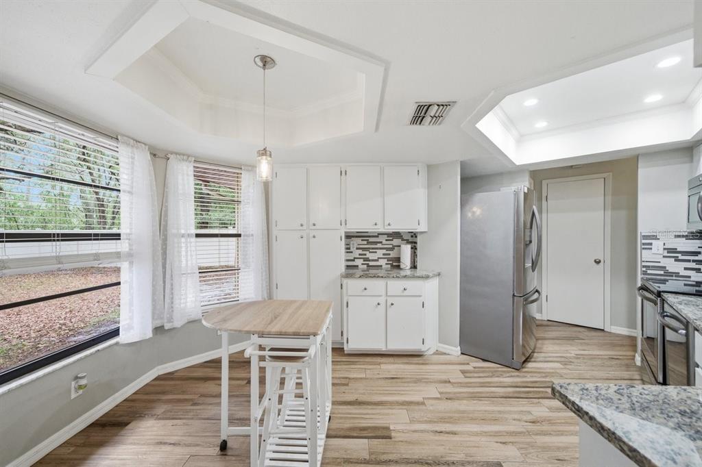 8316 Kingsdale Street Spring Hill, FL 34608 - Photo 11 of 30 a view of a kitchen with furniture and wooden floor