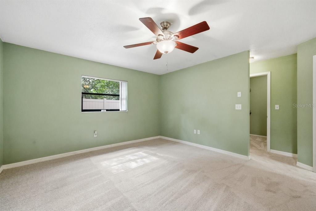 8316 Kingsdale Street Spring Hill, FL 34608 - Photo 13 of 30 an empty room with closet and fan