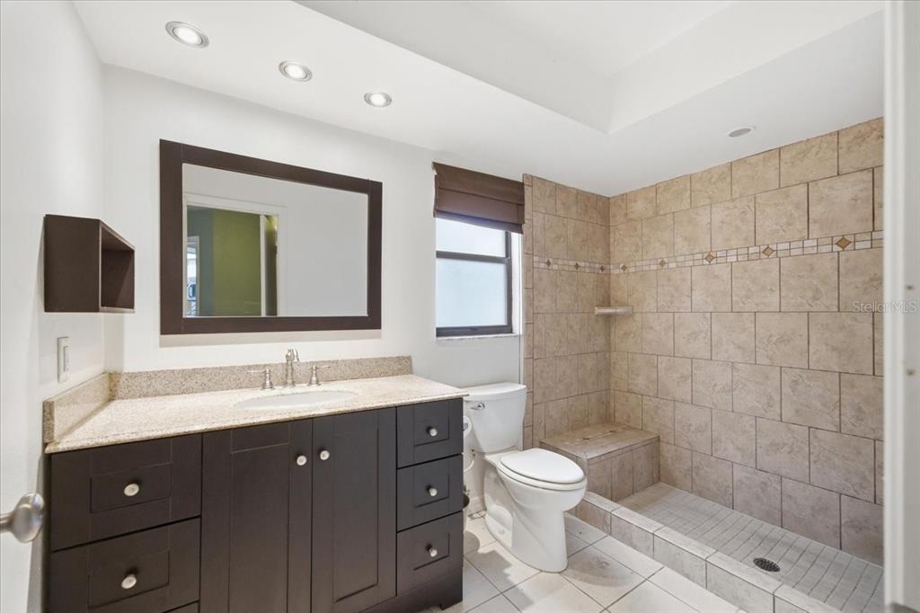 8316 Kingsdale Street Spring Hill, FL 34608 - Photo 15 of 30 a bathroom with a double vanity sink mirror and toilet