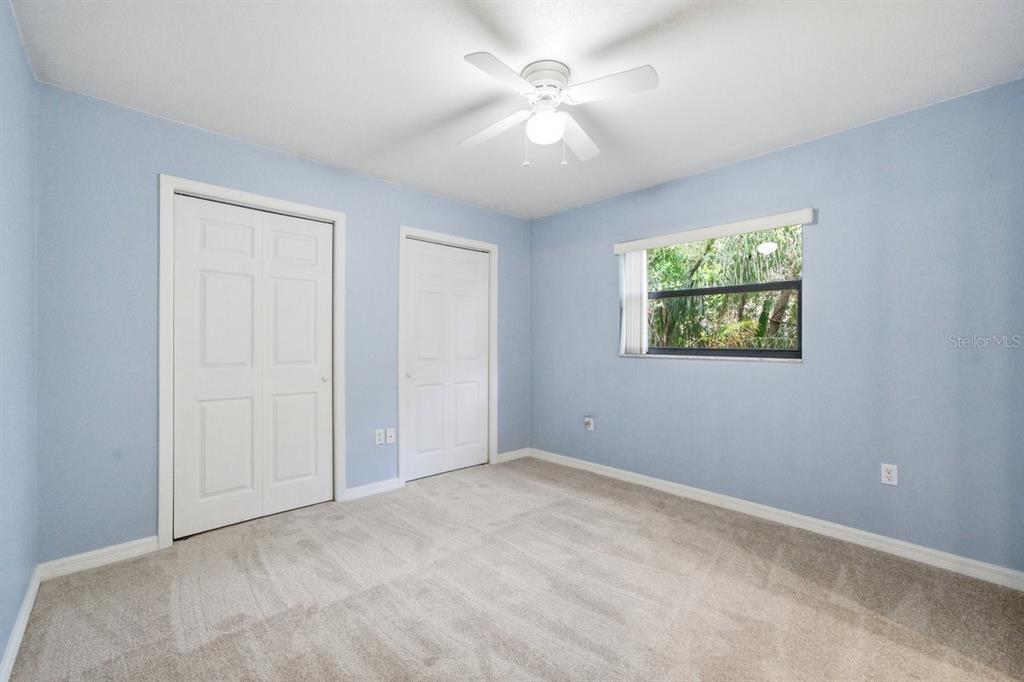 8316 Kingsdale Street Spring Hill, FL 34608 - Photo 17 of 30 an empty room with windows and fan