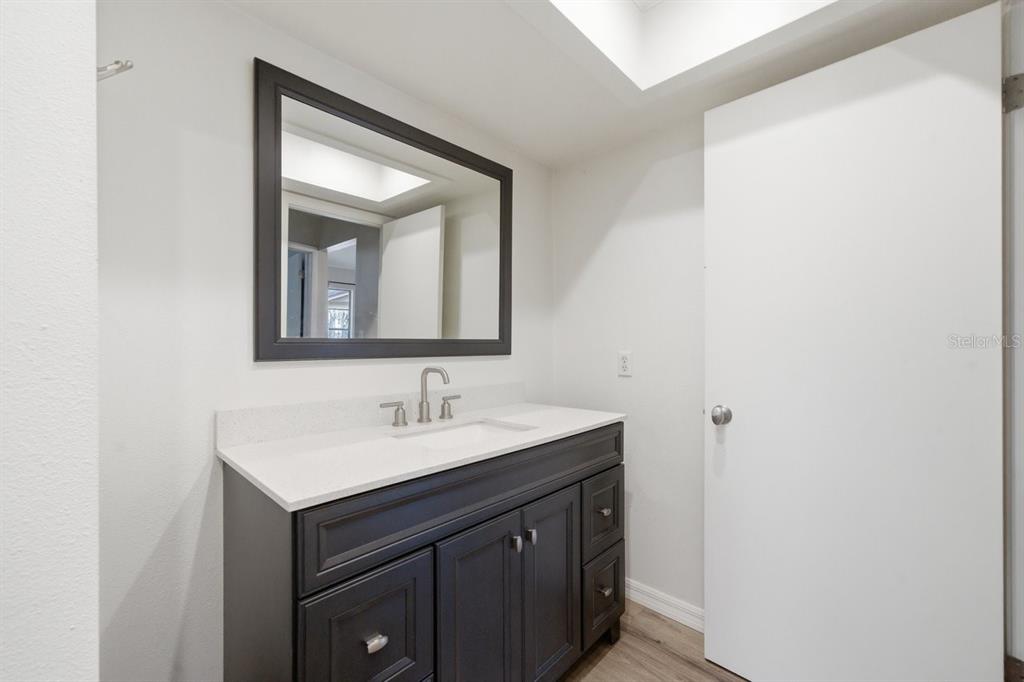8316 Kingsdale Street Spring Hill, FL 34608 - Photo 18 of 30 a bathroom with a sink and a mirror