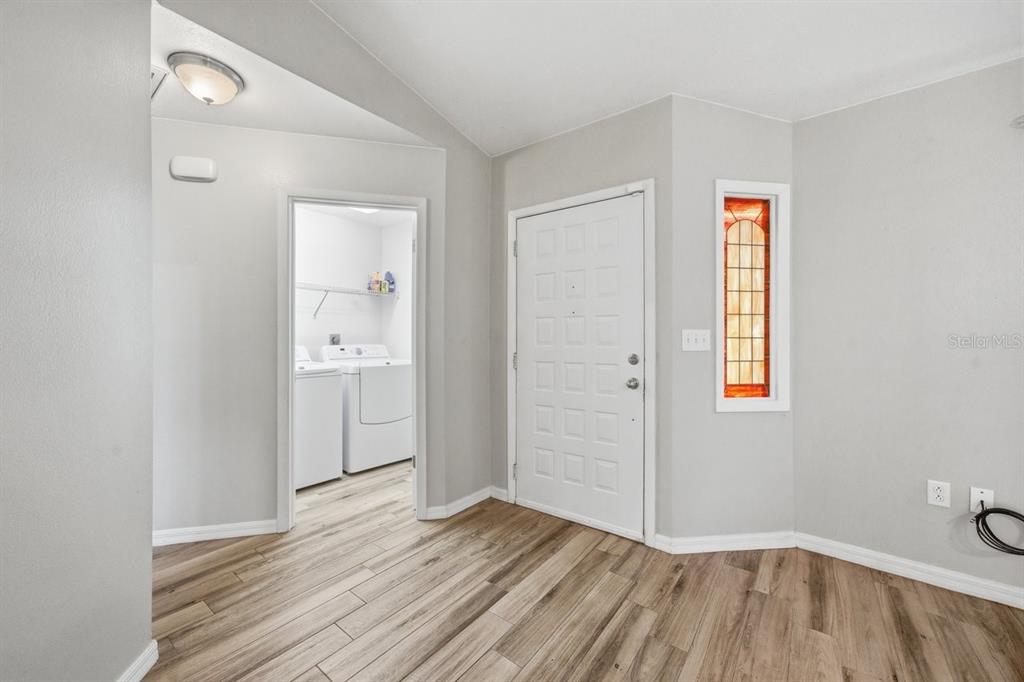 8316 Kingsdale Street Spring Hill, FL 34608 - Photo 3 of 30 an empty room with wooden floor and bathroom