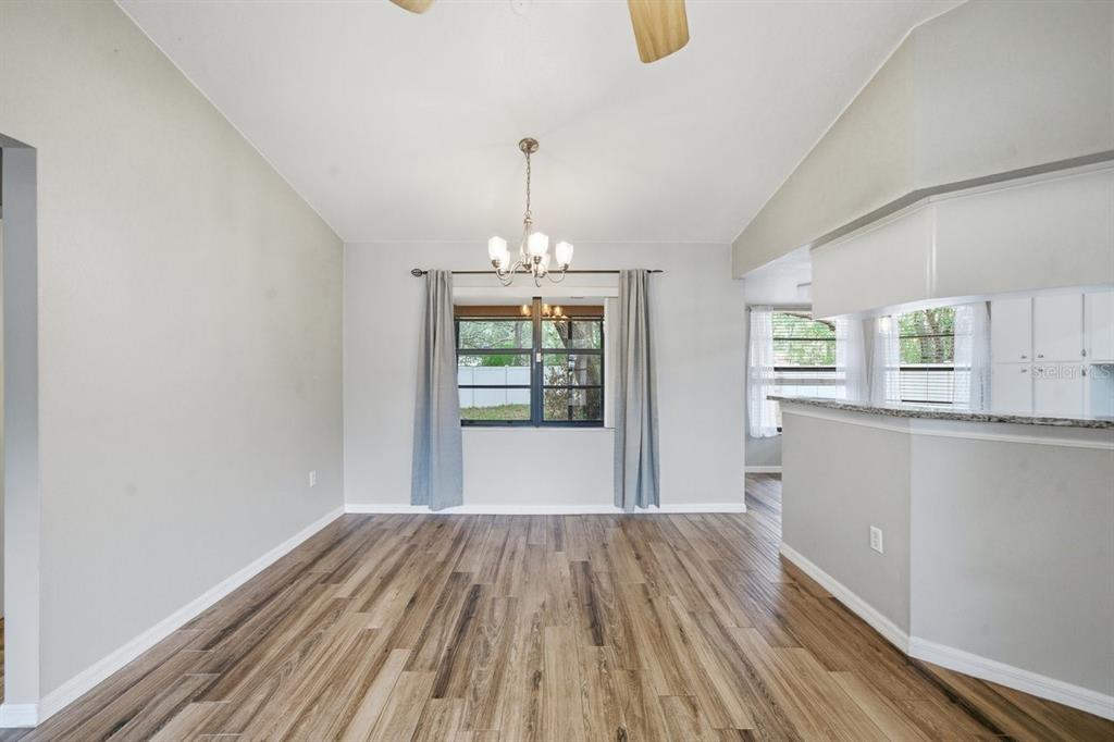 8316 Kingsdale Street Spring Hill, FL 34608 - Photo 6 of 30 a view of empty room with wooden floor and fan