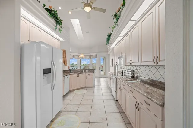 a kitchen with white cabinets and white appliances
