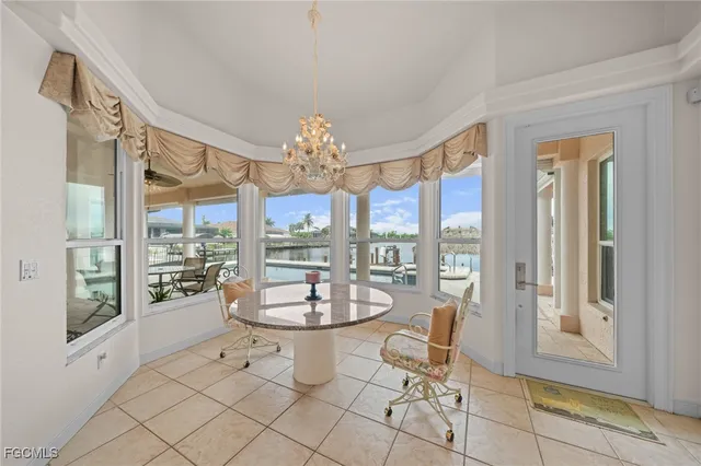 a dining room with furniture a chandelier and fireplace