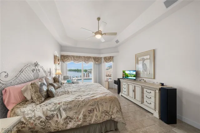 a spacious bedroom with a bed and a chandelier